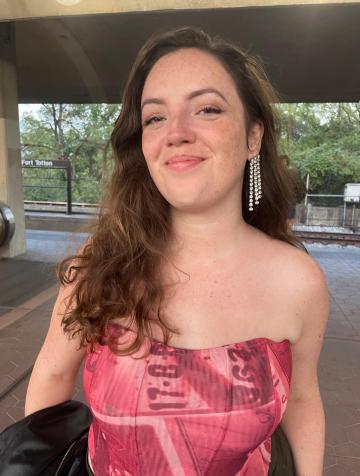 A white woman with brown hair, smiling